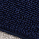 A close up view of a navy Catherine Lansfield bobble mat