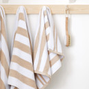 A view of natural striped Bianca Fine Linens hand towel a hook A view of natural striped Bianca Fine Linens hand towel a hook