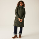 A full length view of a woman wearing a dark khaki green padded coat.