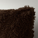 A close up view of a brown Catherine Lansfield fluffy cushion