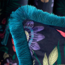 A close up view of a vibrant navy and teal fringed Catherine Lansfiled Mya cushion