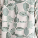 Close-up of sage green leaf print fabric on women’s Craghoppers fleece pullover