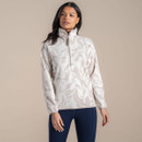 Woman wearing a beige and cream patterned fleece pullover with high collar and half zip.