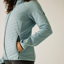 A close up view of a close up view of a hand in one of the jacket's side pockets.