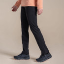 Side view of women’s black Craghoppers walking trousers styled with outdoor trainers.