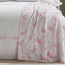 A view of a pink bow Catherine Lansfield blanket on a bed