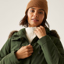 A woman wearing a khaki green jacket with a faux fur hood trim.