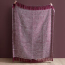 A view of a plum Catherine Lansfield stab stitch blanket