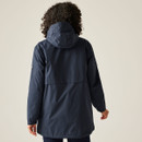The back of a woman wearing a navy jacket with a hood.