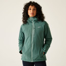 A woman wearing a spruce green coloured hooded jacket.