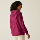 The back of a woman wearing a pink waterproof jacket with a hood.