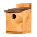 Wooden birdhouse with a dark brown sloped roof and a round entrance hole, mounted on a flat back panel. Simple, rustic design.