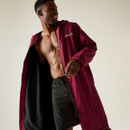 A man wearing a dark red Regatta changing robe with a cosy fleece lining. A man wearing a dark red Regatta changing robe with a cosy fleece lining.