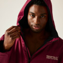 A man wearing a dark red Regatta changing robe with the hood up.