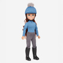 A doll wearing a blue riding helmet with a gray pom-pom, matching blue top, grey riding pants, and black boots, exuding a sporty equestrian vibe.