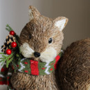A close up view of a brown birsle squirrel Christmas decoration on a side table A close up view of a brown birsle squirrel Christmas decoration on a side table