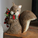 A view of a brown birsle squirrel Christmas decoration on a side table A view of a brown birsle squirrel Christmas decoration on a side table