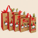 Assorted kraft Christmas gift bags in different sizes, featuring festive gnome designs, red handles, star tags and colourful tissue paper.