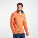 A man wearing an orange quarter zip fleece.