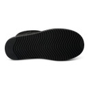 Underside of a black suede boot showing the black rubber outsole with a wavy tread pattern.