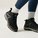 Side view of black walking boots with blue laces, reinforced panels and chunky cushioned soles for outdoor use.