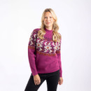 A woman wearing a purple wine coloured knitted jumper with a patterned yoke in shades of cream, orange, and purple.