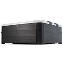Low-angle side view of the MSpa Oslo Plus 6 Person Hot Tub, highlighting its sleek carbon grey wood-effect panels and cushioned headrests along the top edge.