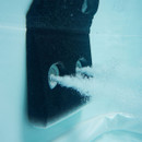 Close-up underwater view of two hydro massage jets in action inside the MSpa Oslo Plus Hot Tub, releasing streams of bubbles for a soothing spa effect.