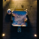 Top-down view of four people enjoying the MSpa Oslo Plus 6 Person Hot Tub at night, with bubbling water and soft ambient lighting on a wooden deck.