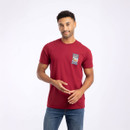 A man wearing a short-sleeved red t-shirt with a small 'Only Fowls and Hawkses' print on the chest.