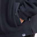 A close up view of a hand in one of the shirt's lower side pocket.