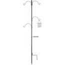 Tall metal garden stake with four curved hooks, a wire bird feeder, and a round tray, conveying a practical and rustic outdoor aesthetic.
