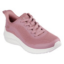 An angled view of a pink lace up trainer with a white sole.