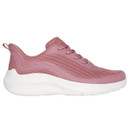A side view of a pink trainer with a white sole.