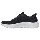 A side view of a black Skechers trainer with a white cushioned sole.
