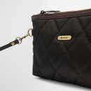 Black quilted handbag with brown trim, featuring gold hardware and a detachable strap. A small gold label displays the brand name "Barbour."