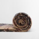 A rolled-up, multicoloured wool blanket with a swirl pattern, featuring shades of brown, tan, and dark blue, against a plain white background. Cosy and soft.