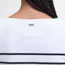 Rear view of a person with braided hair wearing a white top with navy stripes. "Barbour" tag is visible near the neckline on the shirt's back.