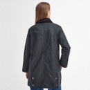 A person with long hair in a black, knee-length coat viewed from the back. The coat features a dark collar and brass buttons, conveying a classic style.