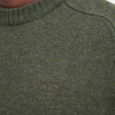 Close-up of a green, textured knit sweater with a ribbed neckline. The "Barbour" logo and emblem are subtly stitched on the fabric.