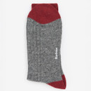 Gray wool sock with red toes, heel, and cuff, featuring a white logo on the side. The texture appears thick and cosy, conveying warmth.