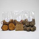 Contents of Grumpy Gardener Bird Food Starter Box – bags of sunflower hearts, suet pellets, and peanuts, with suet cake, fat balls, and filled coconut feeders.