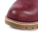 Close-up of the toe area of a burgundy boot, showing smooth leather texture, contrast white stitching, and a thick tan rubber outsole with a treaded edge.