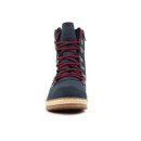 Front view of a navy blue ankle boot with red laces threaded through silver D-ring hooks, beige midsole, brown rubber outsole, and a padded knit collar peeking at the sides.