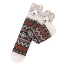 Pair of Totes Toasties novelty slipper socks laid flat, showing bear face design, earthy zigzag knit, and slip-resistant grips on the soles.