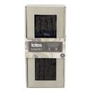 Front view of Totes Toasties Chunky Slipper-Sox packaging in grey with camouflage-style accents. The box features two display windows showing the ribbed dark grey socks inside, along with a label indicating slip-resistant tread, fleece lining, and machine washable. Size: one size fits UK 6–11.