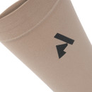 A close up view of sand coloured Shires Aubrion performance socks on a white background