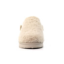 Front view of a beige slip-on slipper featuring a thick, curly fleece-textured upper and a neutral-toned, ridged rubber sole. The slipper has a rounded toe and a cosy, cushioned appearance designed for warmth and indoor comfort.