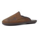 Angled side view of a brown mule-style slipper with a distressed leather-look finish, dark brown trim, and curved upper seam with visible beige stitching at the toe. The side is embossed with the brand name “Lazydogz,” and the dark brown rubber sole features a textured tread, ideal for indoor use.