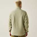 Rear view of a man wearing a beige fleece pullover with a high collar and no visible detailing on the back, showcasing the fleece’s soft texture and relaxed fit.